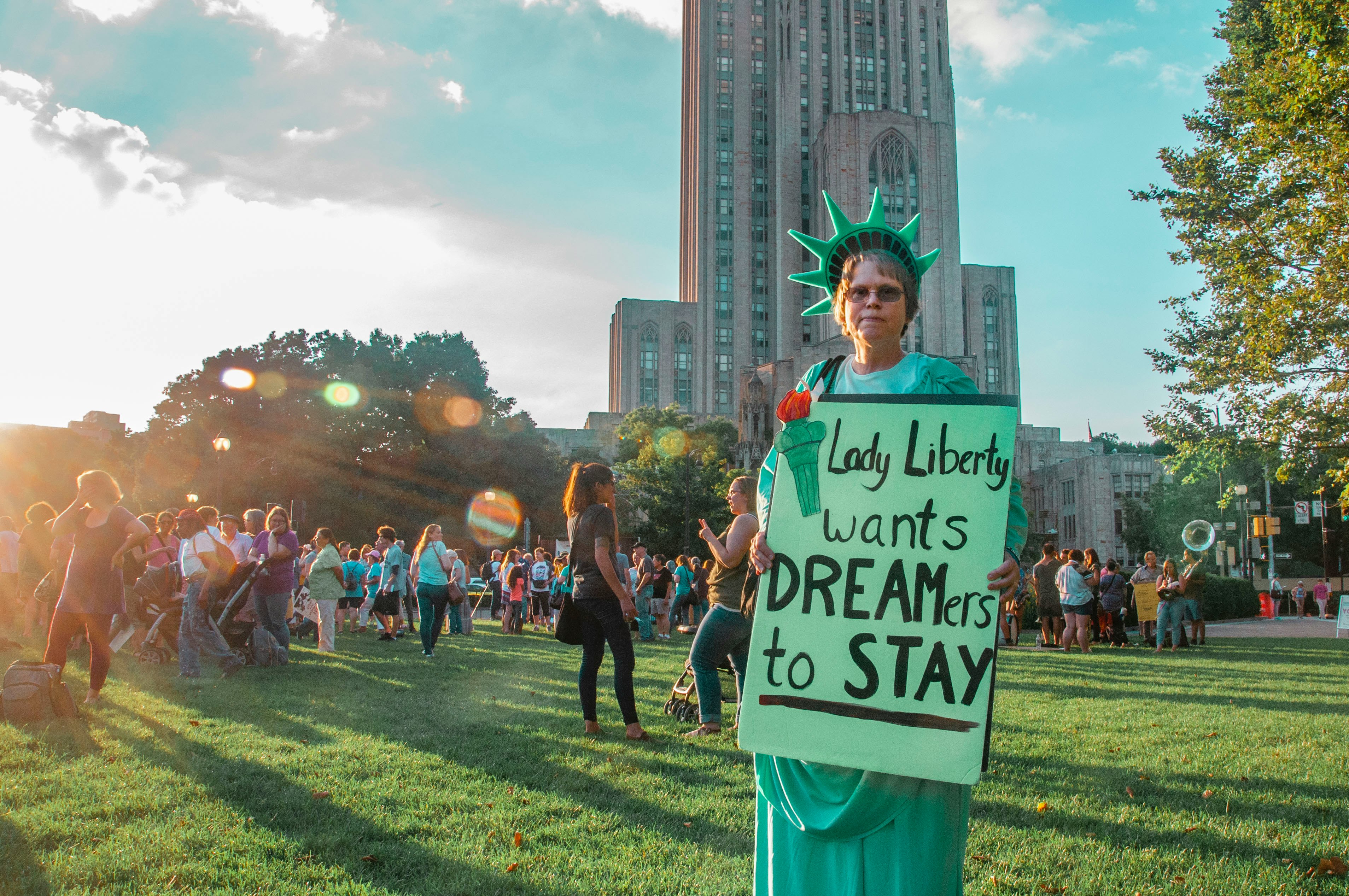 woman holding signage near crowd people